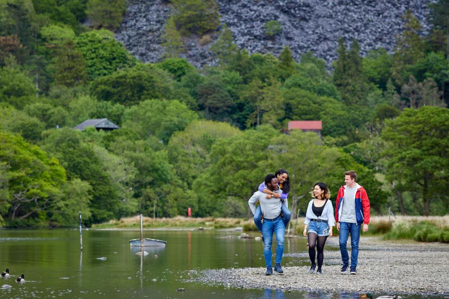Students having fun by the lake in Llanberis